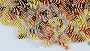 Colored spiral pasta as a background, rotate clockwise.
