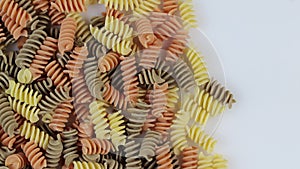 Colored spiral pasta as a background, rotate clockwise.