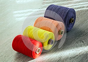 Colored spools of thread for sewing, side view