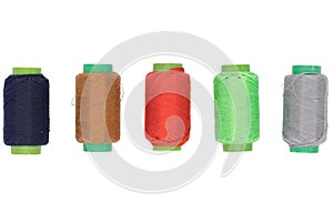 Colored spools of thread on a white background