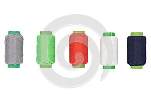 Colored spools of thread on a white background