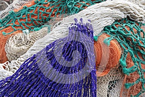 Colored stacked fishing nets in port