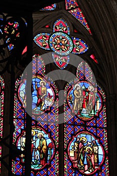 Colored stained-glass windows decorate one of the chapels of Bayeux cathedral (France)