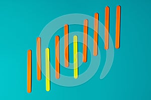 Colored sticks in the form of a graph of profit against the background of the color of sea water