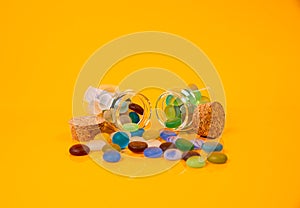 colored stones in glass in jar in bucket on orange background