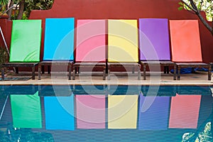 Colored sun loungers by pool