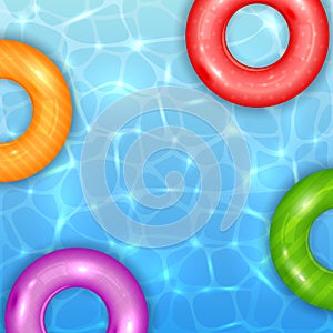 Colored Swim Rings on Water Background