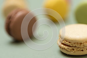 Colored tasty  macaroons over a green background