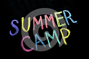 Colored text summer camp on blackboard