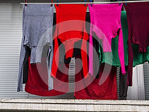 Colored textile laundry. Colored vibrant colors purple, red and gray.