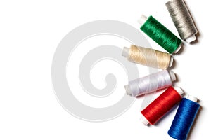 Colored thread coils on white background, sewing, handmade and DIY concept - layout for hobby and DIY such as dressmaking