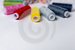 Colored thread for sewing. White background. Circle of spools of thread. Side view.