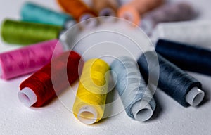 Colored thread for sewing. White background. Circle of spools of thread. Side view.