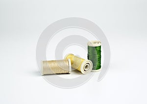 Colored thread spools on a white background