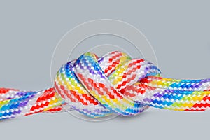 Colored threaded cords knotted together isolated