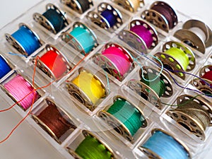 colored threads, sewing machine bobbins, sewing accessories