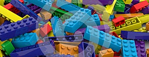 Colored toy bricks background. Rainbow colors. Random coloured plastic construction blocks. 3D illustration. 3D