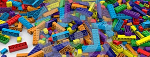 Colored toy bricks background. Rainbow colors. Random coloured plastic construction blocks. 3D illustration. 3D