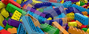 Colored toy bricks background. Rainbow colors. Random coloured plastic construction blocks. 3D illustration. 3D