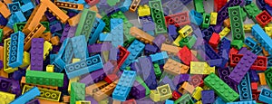 Colored toy bricks background. Rainbow colors. Random coloured plastic construction blocks. 3D illustration. 3D