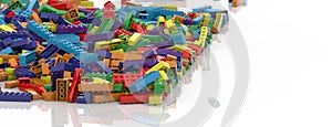 Colored toy bricks background. Rainbow colors. Random coloured plastic construction blocks. 3D illustration. 3D