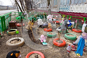 Colored toys, tires and dolls around a home