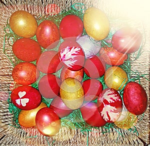 Colored traditional painted easter eggs in a brown basket
