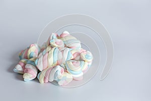 Colored twisted marshmallow on white background. Side view