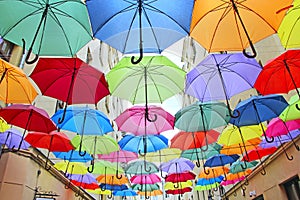 Colored umbrellas hanging at the top. Local landmark. Bold colors