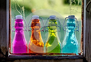 Colored Vintage Bottles on Window Sill