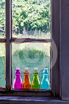 Colored Vintage Bottles on Window Sill