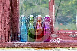 Colored Vintage Bottles on Window Sill