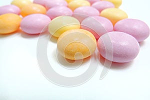 Colored vitamins pills, white background