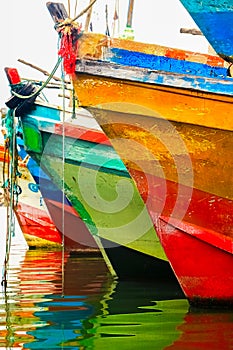 Colored water reflections . Colorful boats in the seaport .