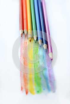 Colored watercolor pencils paint a rainbow. Creation