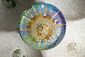 Colored wheel mosaic of colored ceramic tile by Antoni Gaudi at his Parc Guell, Barcelona, Spain