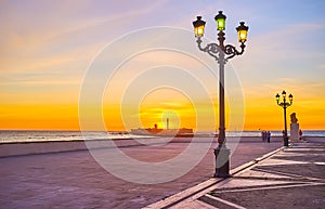 The colored wintage lanterns on oceanside promenade of Cadiz, Spain photo