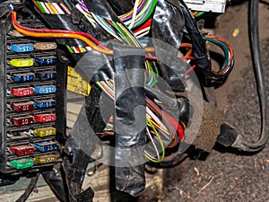 Colored wires and fuse box of the car`s internal electrical wiring