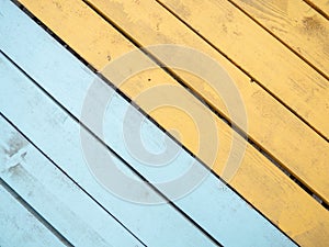 Colored wood flooring. Knocked together boards of blue and yellow colors. Board background