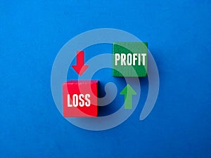 Colored wooden block with the word LOSS PROFIT with colored arrow