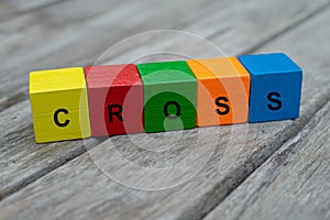 Colored wooden cubes with letters. the word cross is displayed, abstract illustration