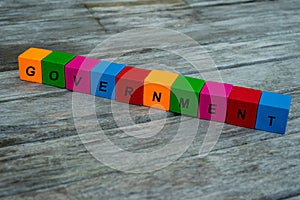 Colored wooden cubes with letters. the word government is displayed, abstract illustration