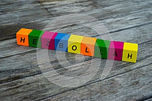 Colored wooden cubes with letters. the word hezbollah is displayed, abstract illustration