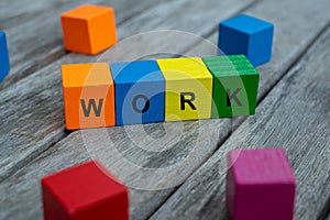 Colored wooden cubes with letters. the word work is displayed, abstract illustration