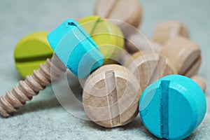 Colored wooden screws bolts repair tool children`s toy interesting background