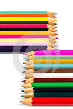 Colored wooden sharpened pencils for office and school on a white background