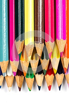 Colored wooden sharpened pencils for office and school on a white background