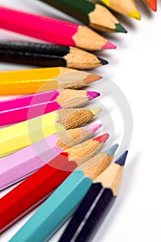 Colored wooden sharpened pencils for office and school on a white background photo