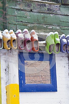 Colored wooden shoes on wall