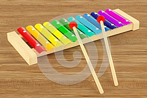 Colored Xylophone on the wooden table. 3D rendering